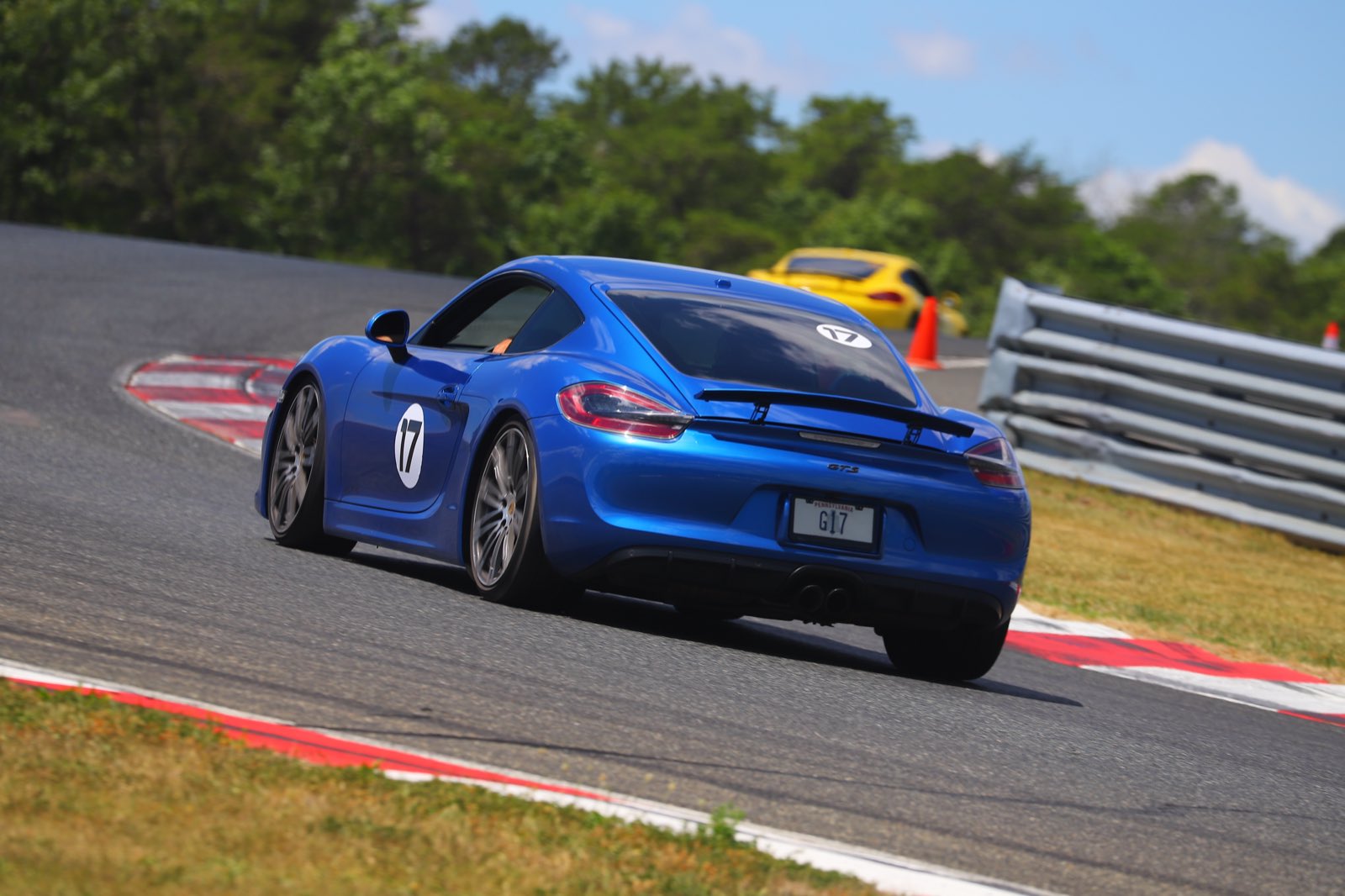 The GrahamStone Cayman GTS running down a yellow Cayman through the NJMP curbing