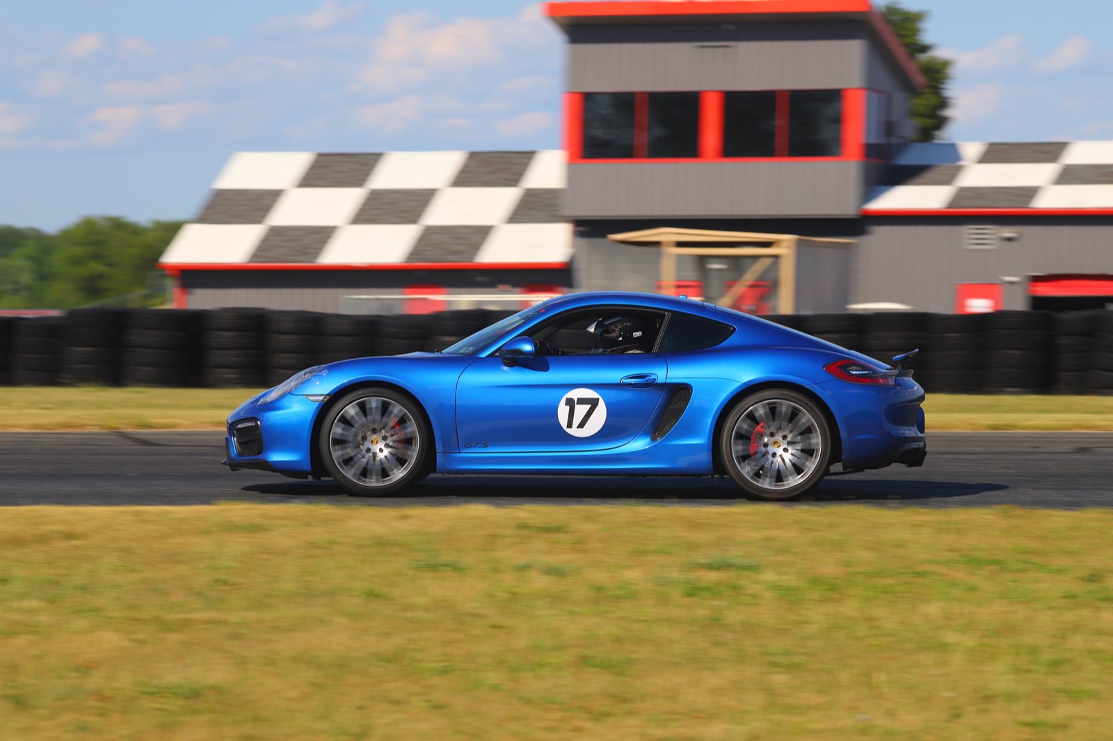The number 17 Cayman GTS crossing the start-finish line at NJMP Lightning