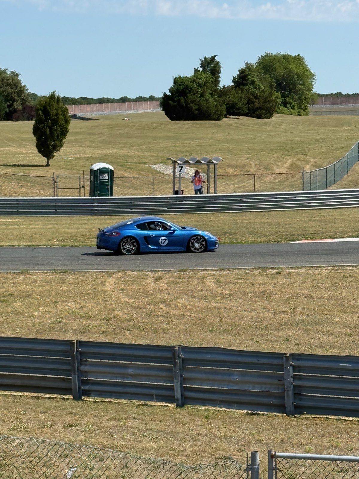 The number 17 Cayman GTS passing the turn 7 flag station at NJMP