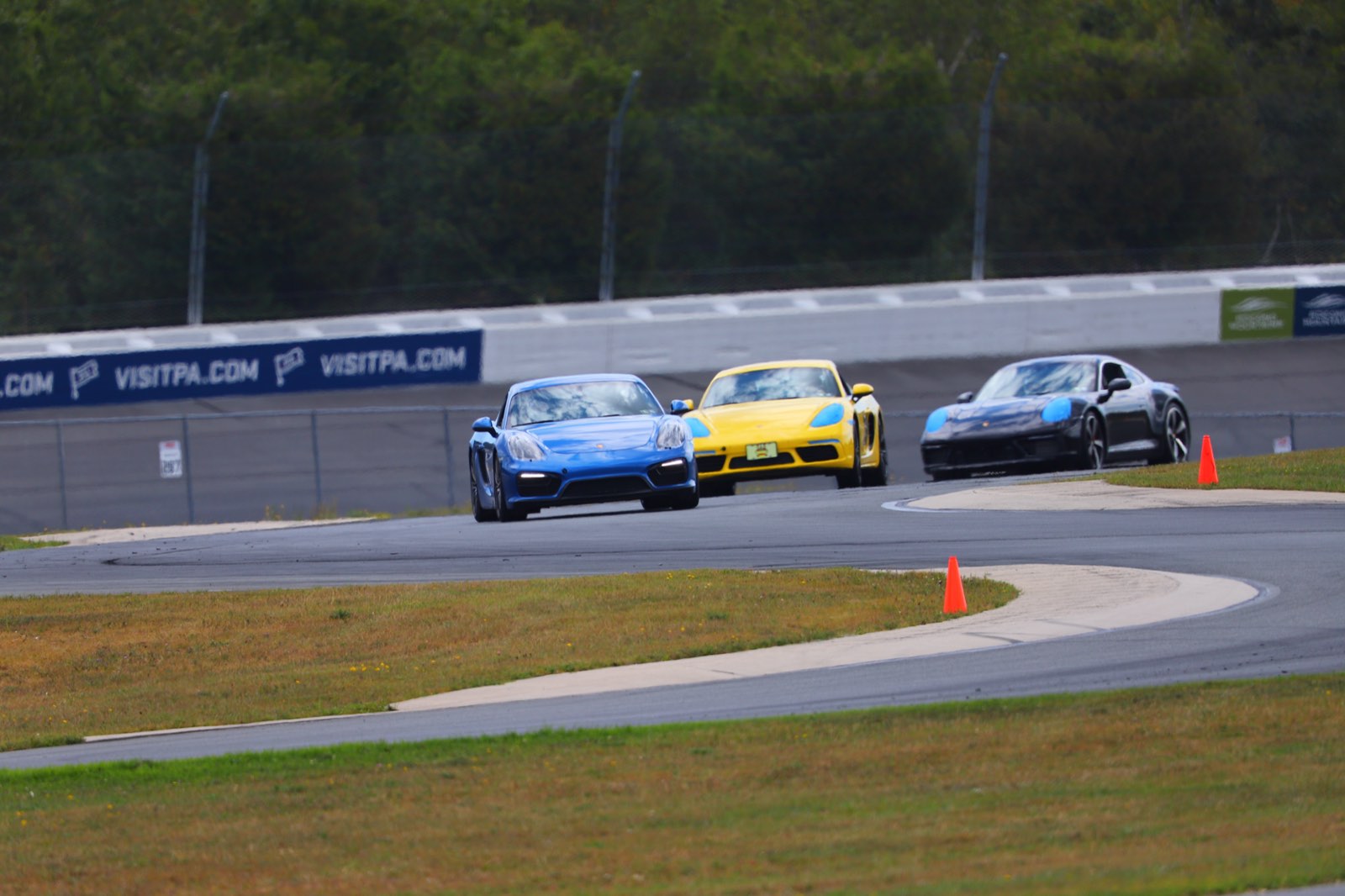 Three Porsches through the Pocono infield esses, the GrahamStone Cayman GTS out front